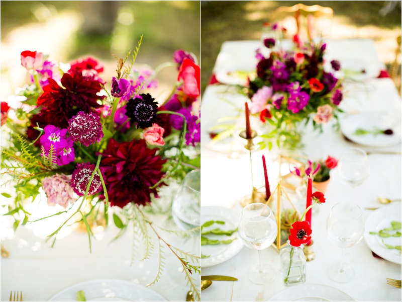 A beautiful boquet popping with red and purple color on a painted white wood table