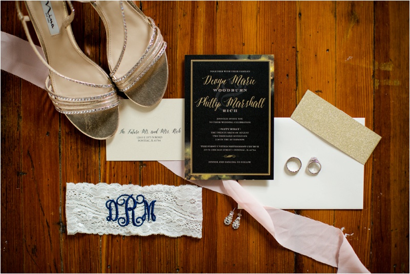 wedding stationary, white garter with dark blue monogram, engagement rings and bands, and wedding heels