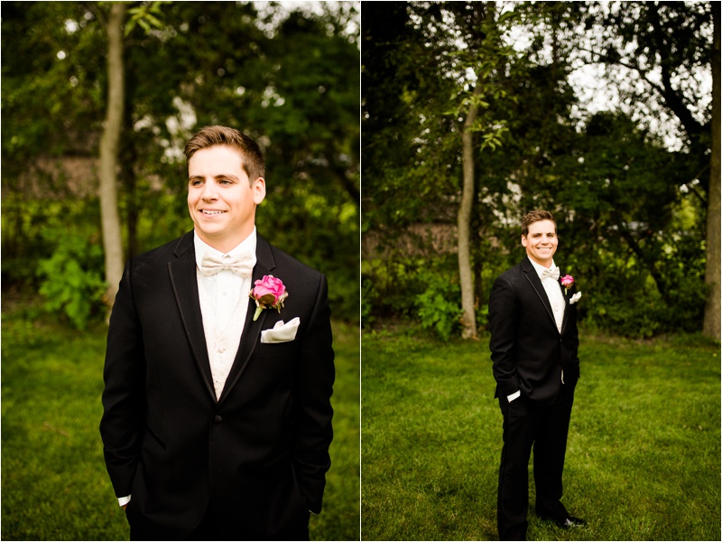 groom in a black suit with a gold bowtie and pink boutonniere 