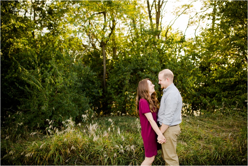 Young couple smiling at each other during fun engagement session