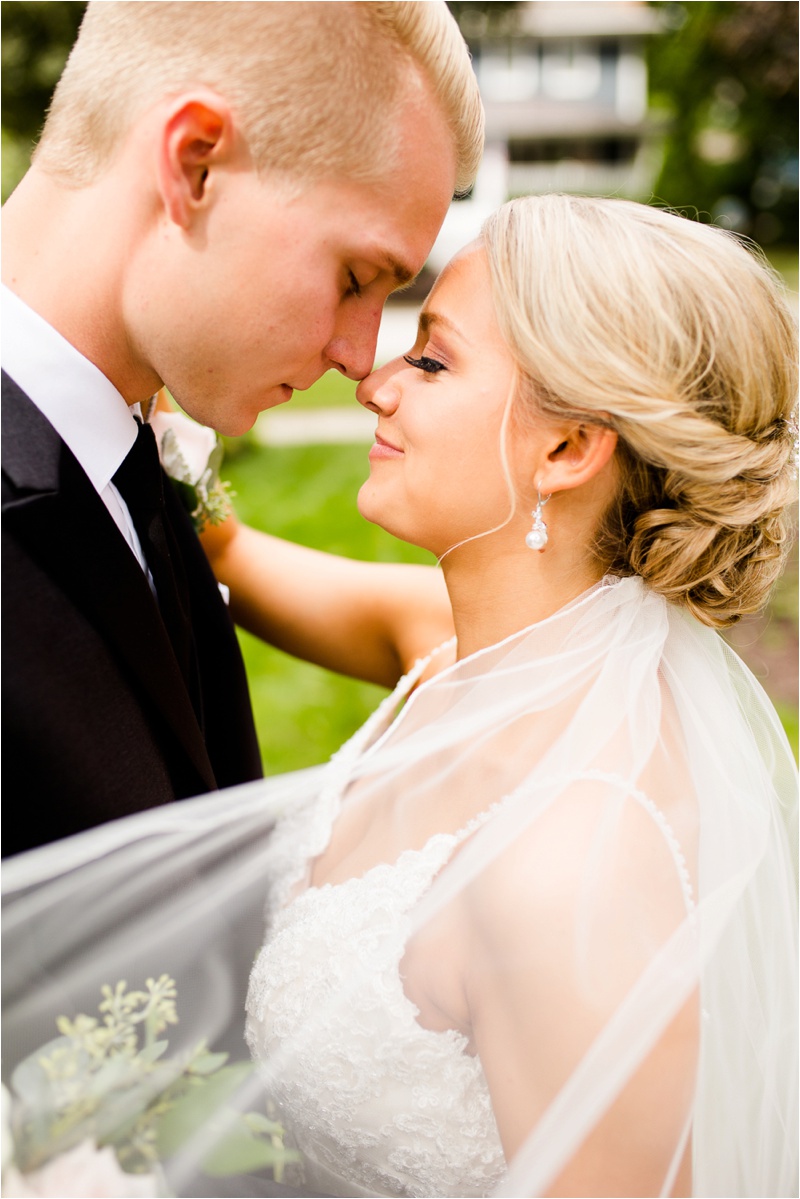 close up shot of the bride and groom touching noses together