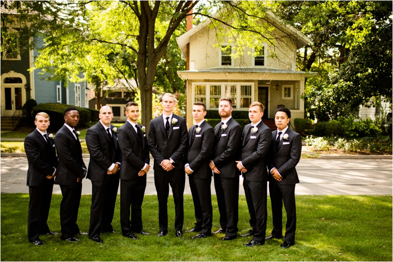 groomsmen and groom looking serious at the camera