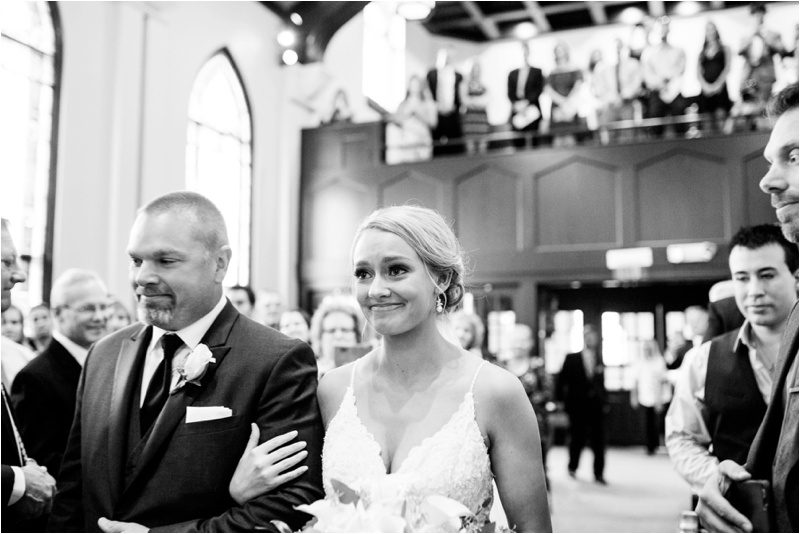 Dad walks the bride down the aisle as she is filled with emotion