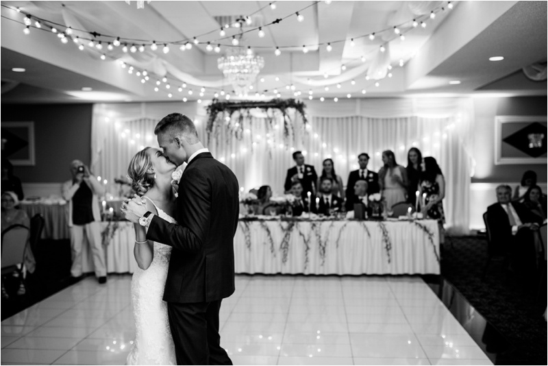 Black and white picture of bride and groom having their first dance