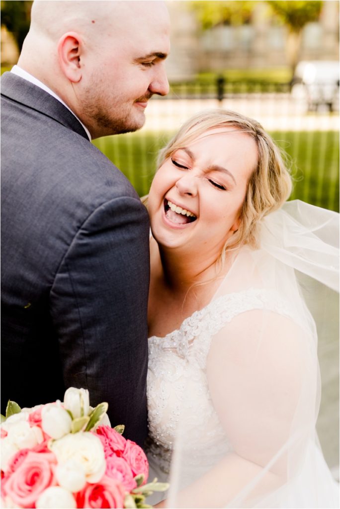 Candid laughing bride portrait with groom, showing genuine emotion in outdoor wedding photos