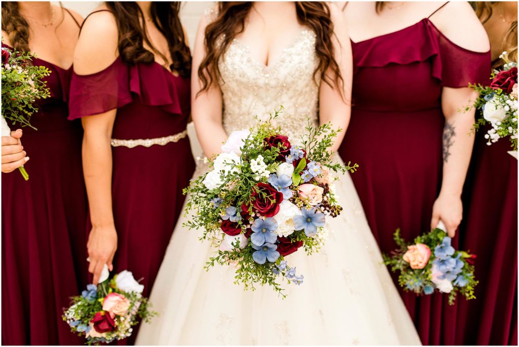 portraits of bridesmaids in red gowns in IN by Caitlin and Luke Photography, Indianapolis wedding photographers, Carmel IN wedding photographers
