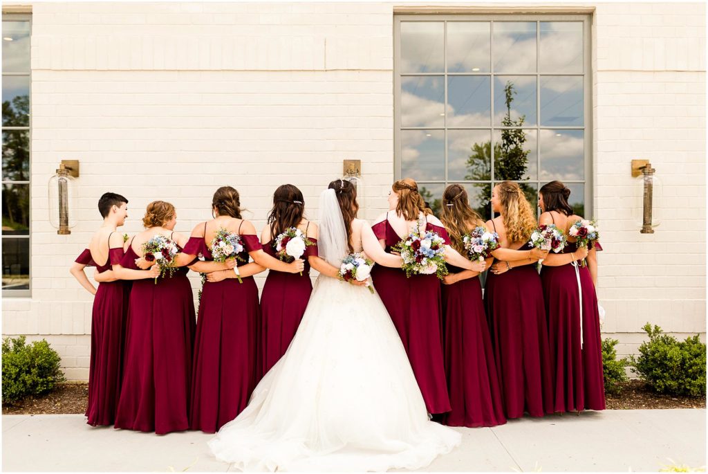 portraits of bridesmaids in red gowns in IN by Caitlin and Luke Photography, Indianapolis wedding photographers, Carmel IN wedding photographers