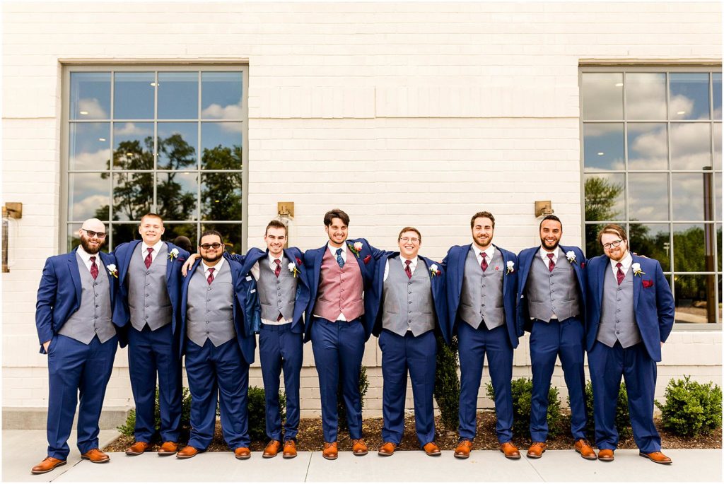 portraits of groomsmen in navy suits in IN by Caitlin and Luke Photography, Indianapolis wedding photographers, Carmel IN wedding photographers