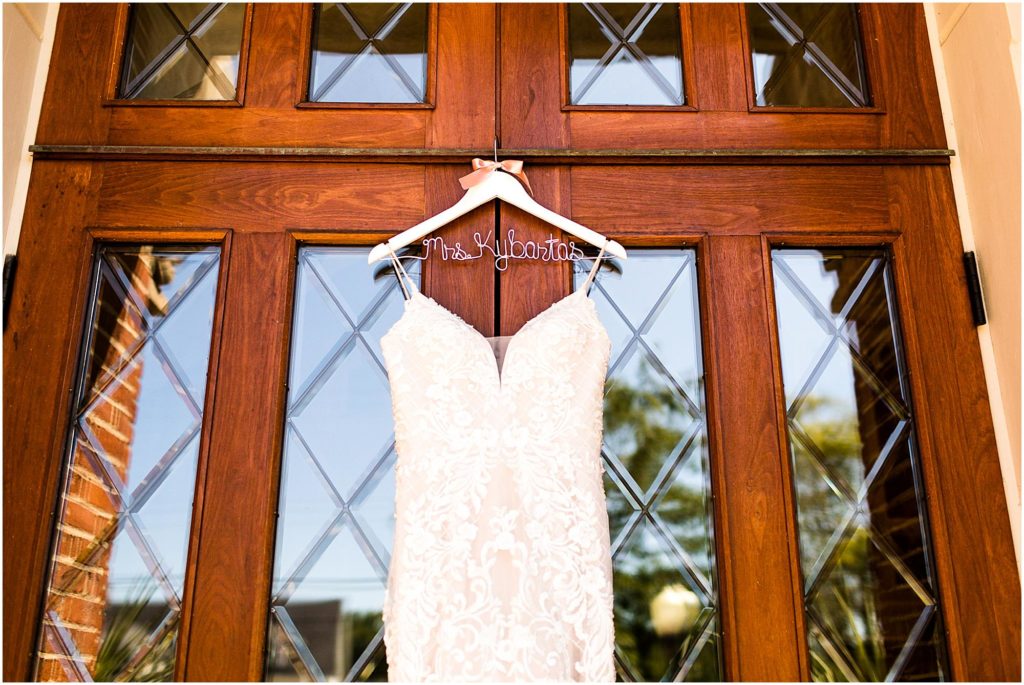wedding dress hanging on door by Caitlin and Luke Photography, St. Michael's Church wedding, Fort Loramie OH wedding photographers, church wedding, Ohio wedding photographers