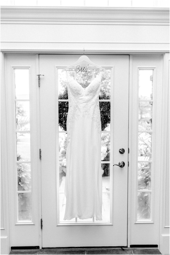 bride's dress hangs in childhood home photographed by Caitlin and Luke Photography, Bloomington Wedding Photographers, Illinois Wedding Photographer, Holiday Inn & Suites Bloomington Wedding Photos