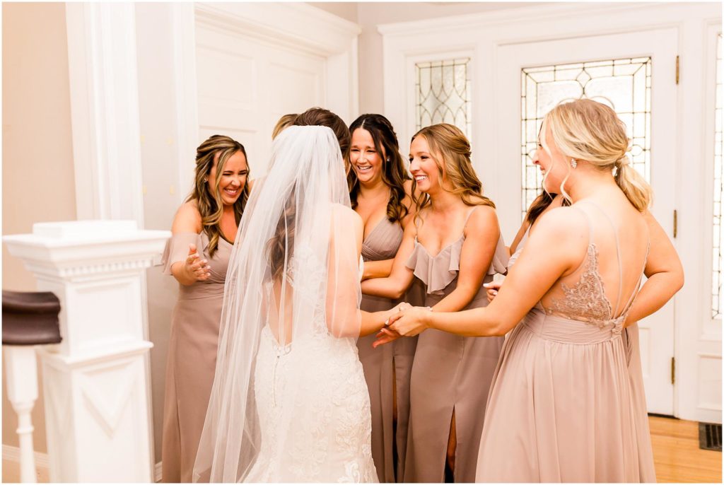 first look for bride and bridesmaids before Pritzlaff Events wedding in Milwaukee WI photographed by Wisconsin wedding photographers Caitlin and Luke Photography