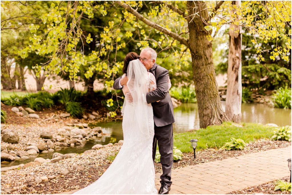 first look with bride and dad before spring Pear Tree Estate wedding photographed by Champaign Illinois wedding photographers Caitlin and Luke Photography
