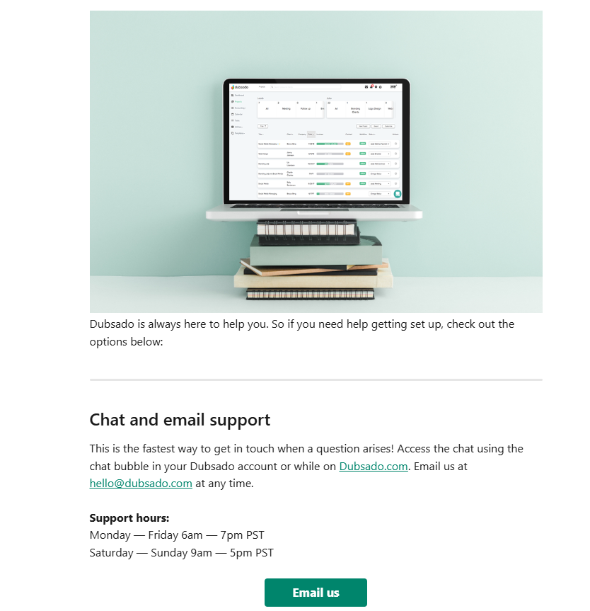 Dubsado’s customer support page with a laptop on stacked books, emphasizing chat and email support in the Dubsado vs Honeybook comparison.